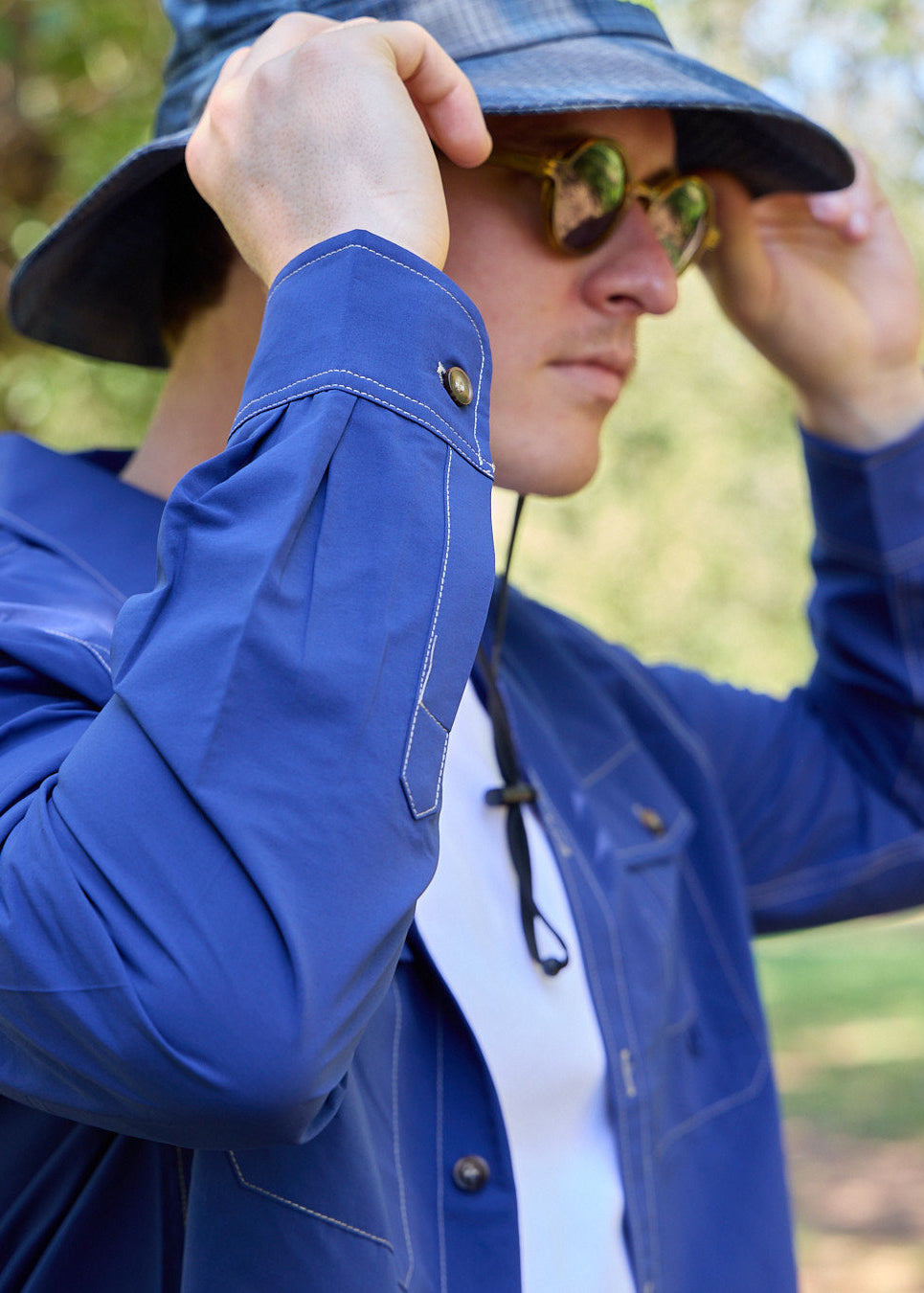Person wearing a blue Sun Ray UPF50+ sun protection overshirt sun shirt