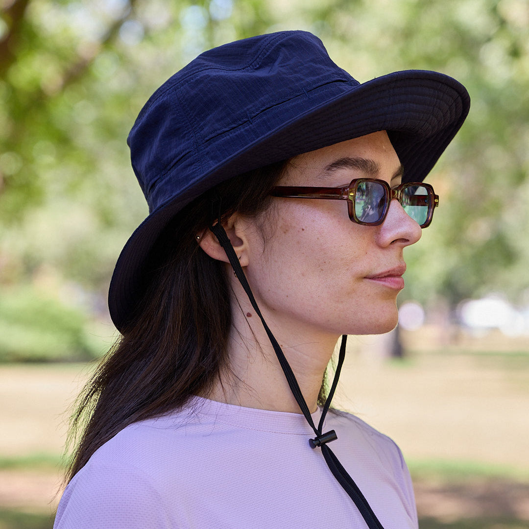 A sun smart woman wears the Sun Ray UPF50+ Sun Protection Breezy Brimmer Hat