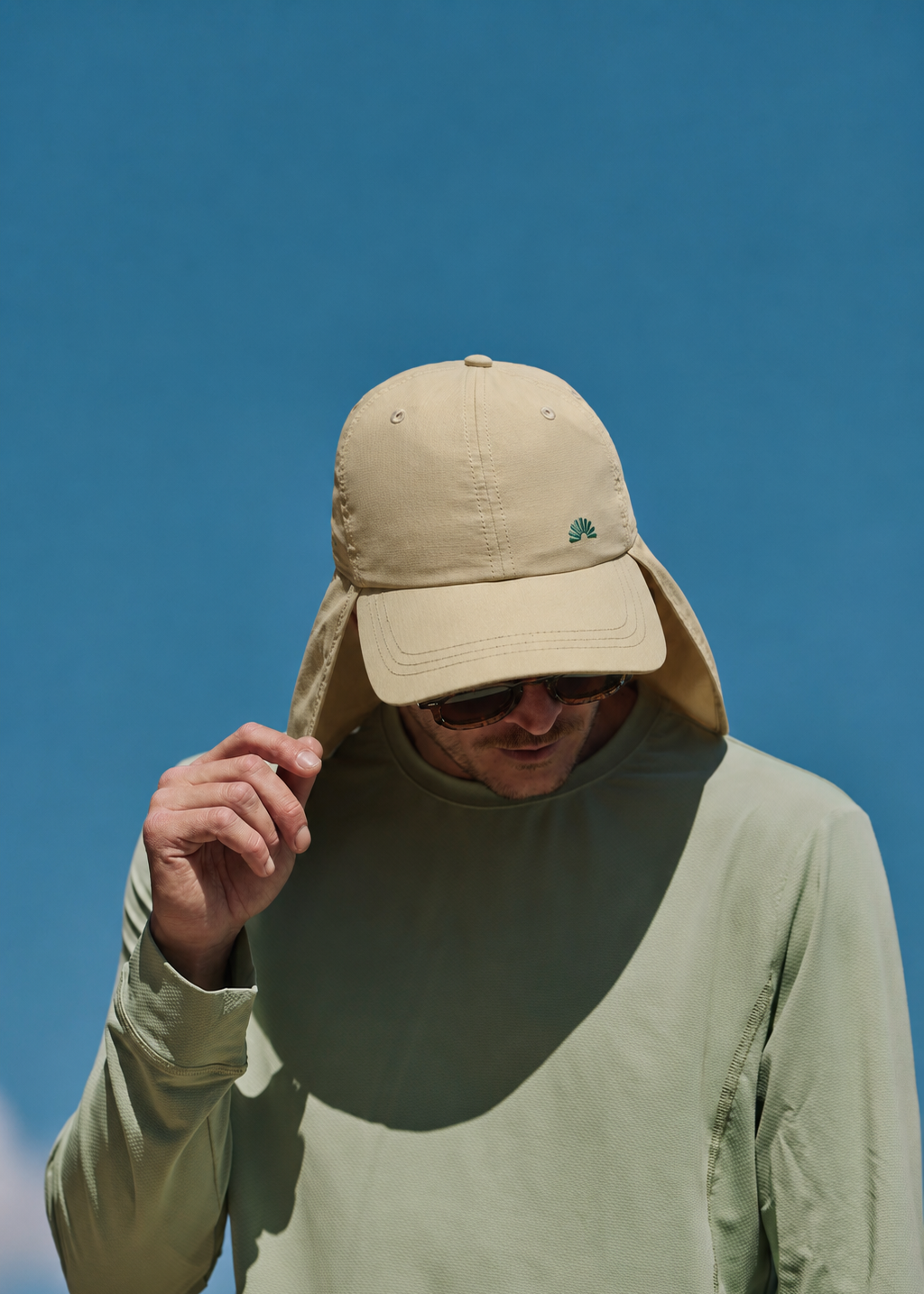 A man wearing a stone legionnaire sun hat with a neck flap and a light sage green long-sleeve shirt UPF50+ Sun Ray