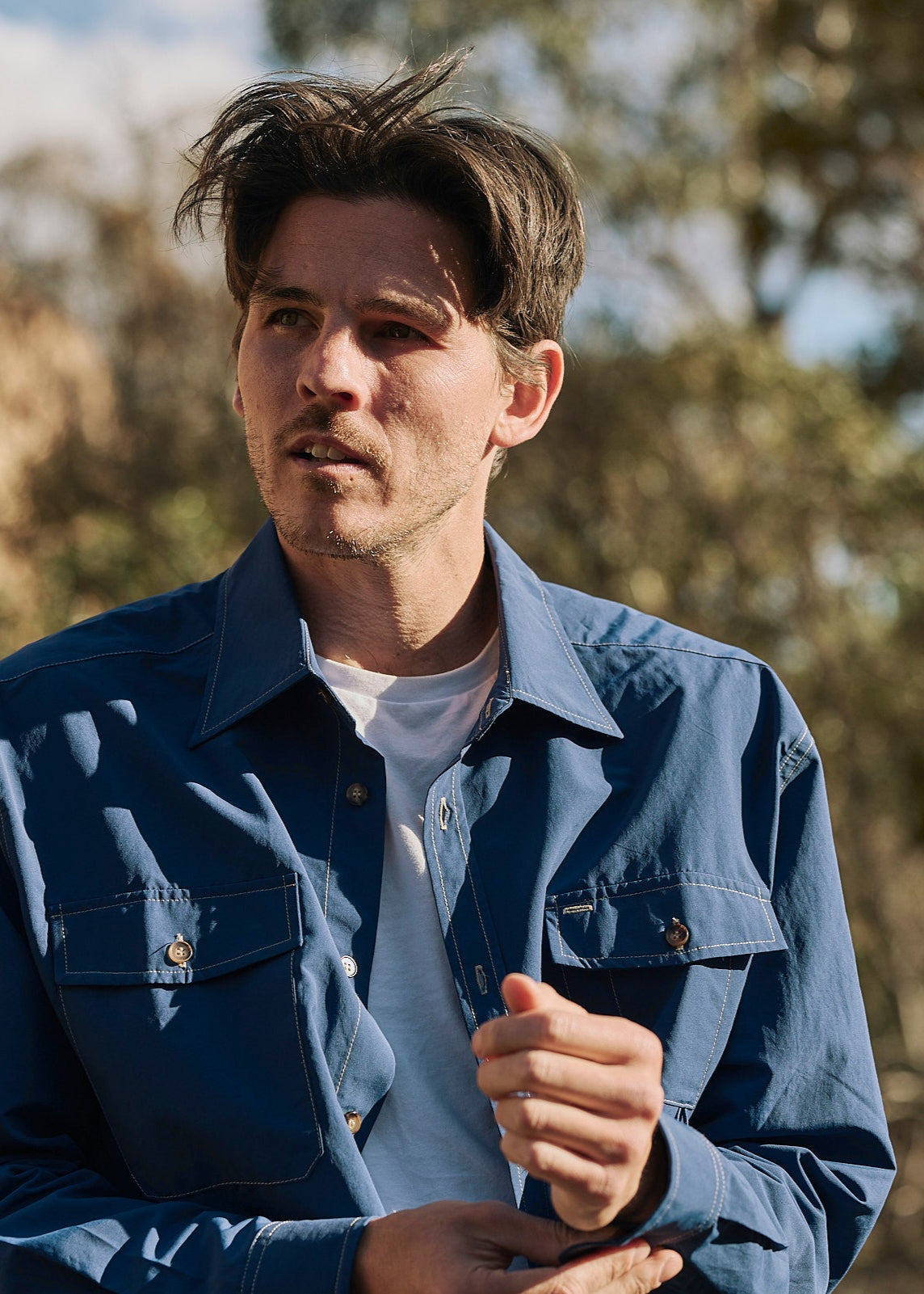 Person wearing a blue Sun Ray UPF50+ sun protection overshirt sun shirt