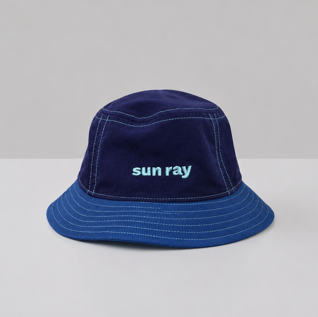 A navy blue kids bucket hat with detachable neck flap made from UPF50+ fabric.