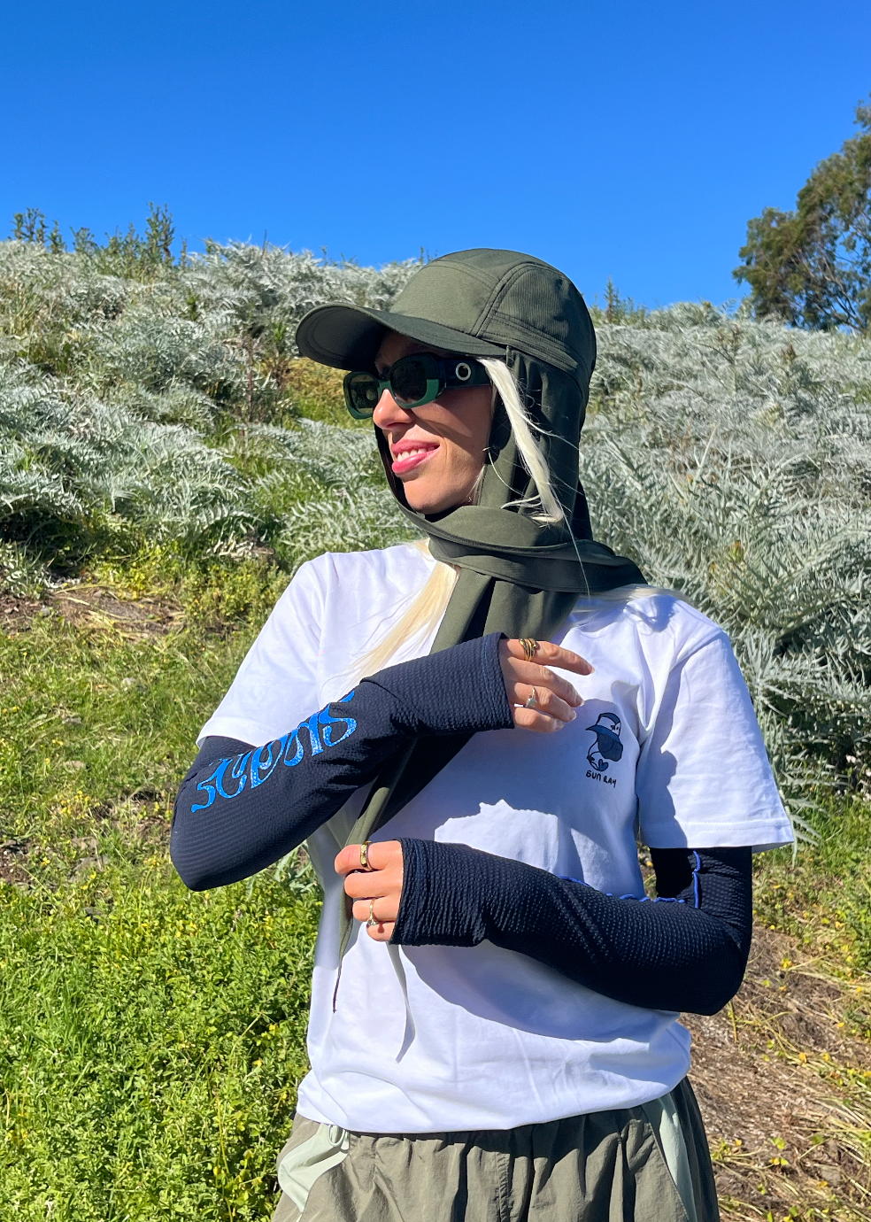 Woman wearing Sun Ray UPF50+ Shaded Scarf Cap in olive with the neck scarf wrapped