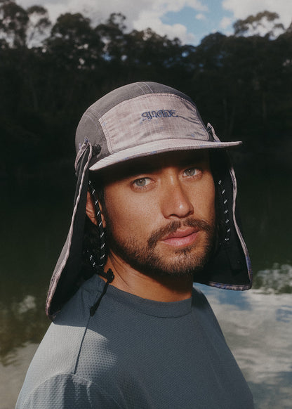 Runner wearing Sun Ray UPF50+ Stay-Put Flap Cap with neck flap on a trail