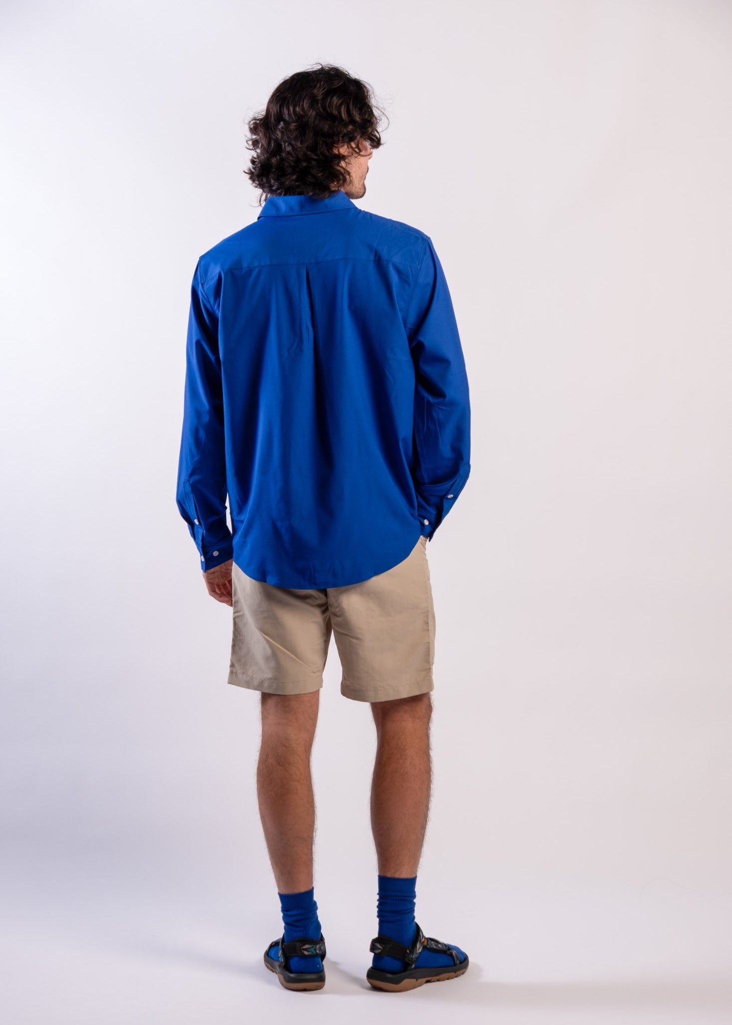Person wearing a blue UPF50+ Sun protection sun shirt on a white background