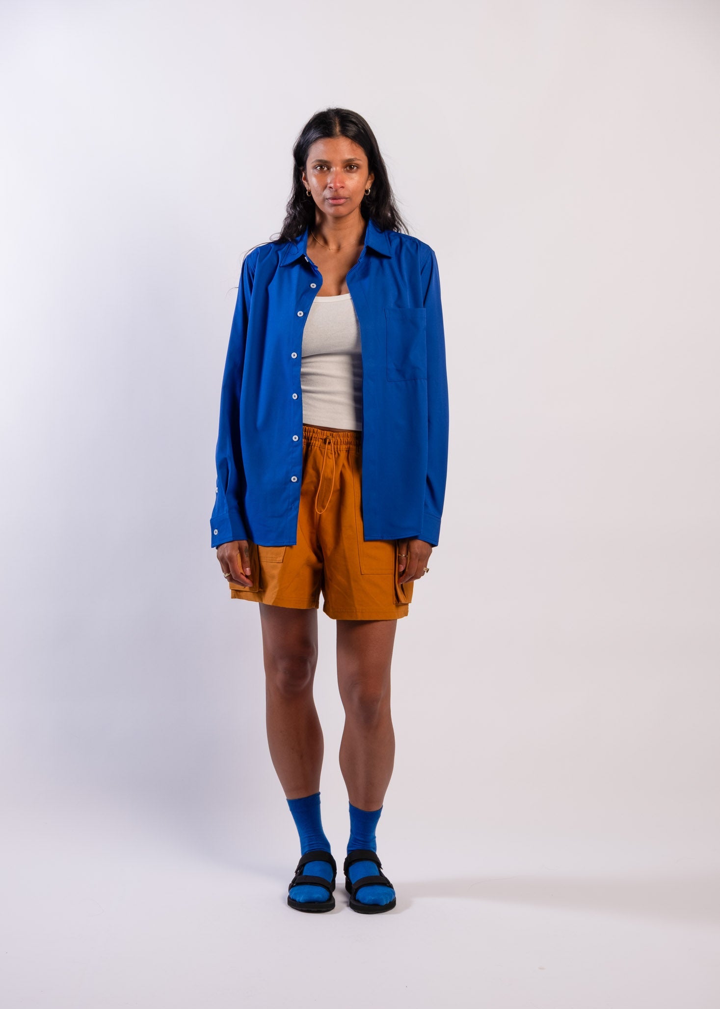 Person wearing a blue UPF50+ Sun protection sun shirt on a white background