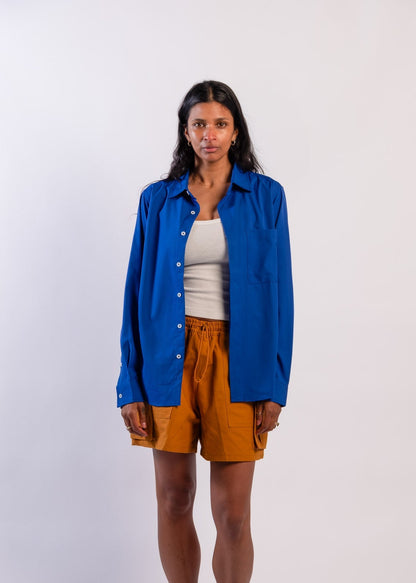 Person wearing a blue UPF50+ Sun protection sun shirt on a white background