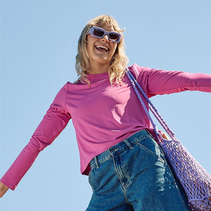 A sun smart woman wears the Sun Ray UPF50+ Sun Protection Clothing All G Long Sleeve Tee fuchsia boxy fit and Shade Cap in Australia